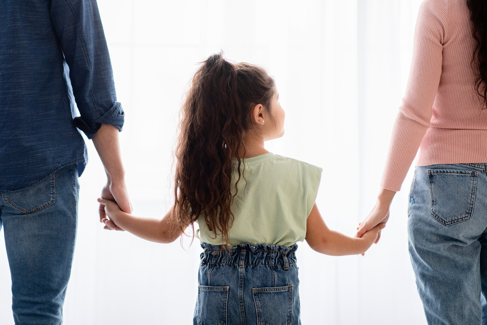 Family Support Concept. Little Girl Holding Hands With Mom And Dad, Closeup